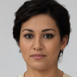 Joyful latino young-adult female with short  brown hair and brown eyes