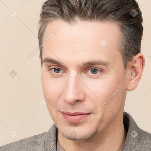 Joyful white adult male with short  brown hair and brown eyes