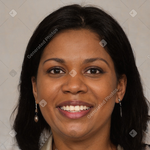 Joyful black adult female with long  brown hair and brown eyes