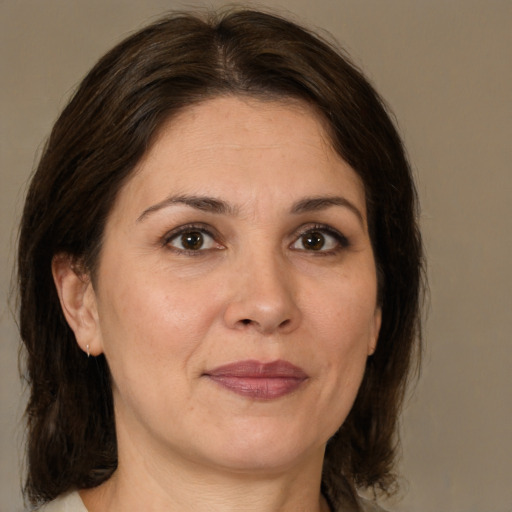 Joyful white adult female with medium  brown hair and brown eyes