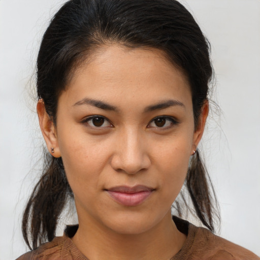 Joyful asian young-adult female with long  brown hair and brown eyes