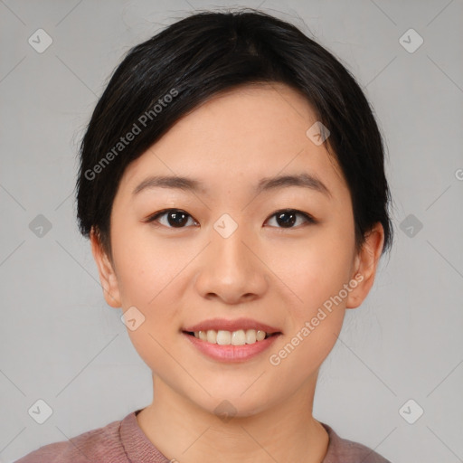 Joyful asian young-adult female with short  black hair and brown eyes