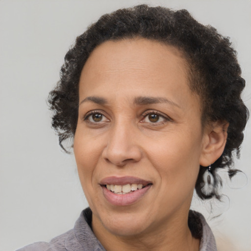 Joyful black adult female with short  brown hair and brown eyes