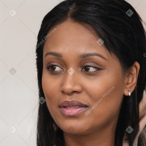 Joyful black young-adult female with long  black hair and brown eyes