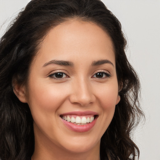 Joyful white young-adult female with long  brown hair and brown eyes