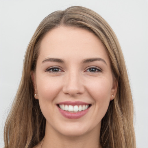 Joyful white young-adult female with long  brown hair and grey eyes