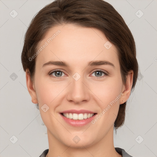 Joyful white young-adult female with medium  brown hair and grey eyes