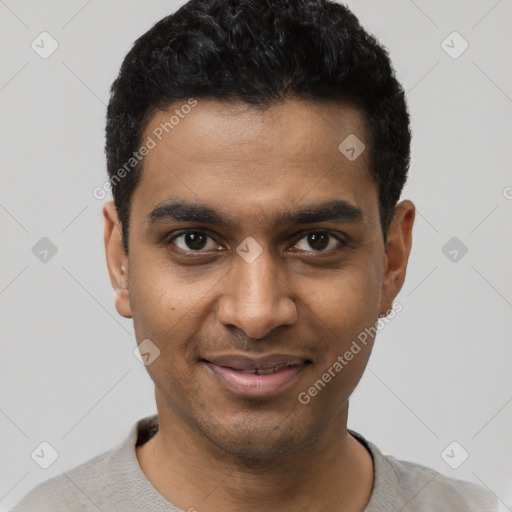 Joyful black young-adult male with short  black hair and brown eyes