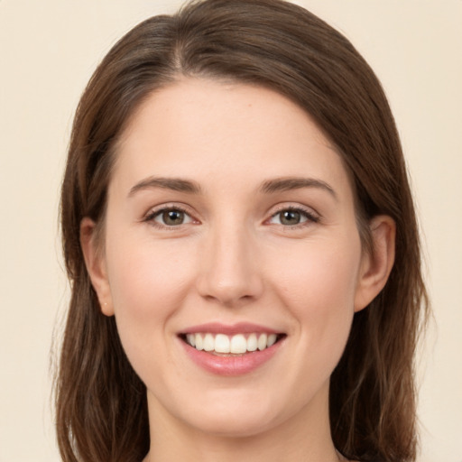 Joyful white young-adult female with long  brown hair and green eyes