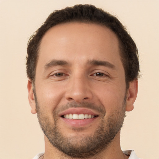 Joyful white young-adult male with short  brown hair and brown eyes