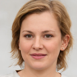 Joyful white young-adult female with medium  brown hair and green eyes