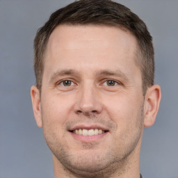 Joyful white adult male with short  brown hair and brown eyes