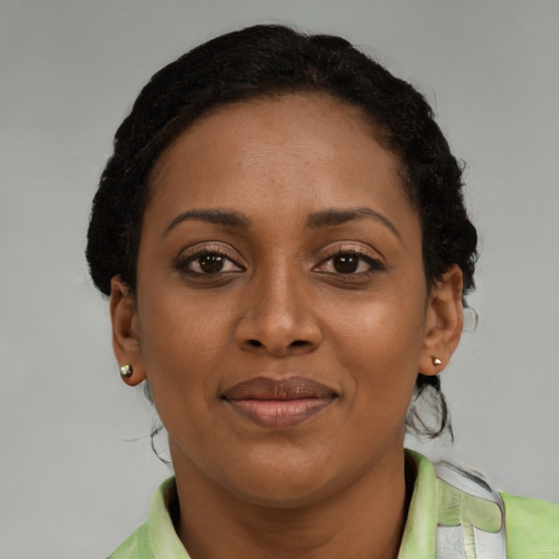 Joyful black young-adult female with short  brown hair and brown eyes