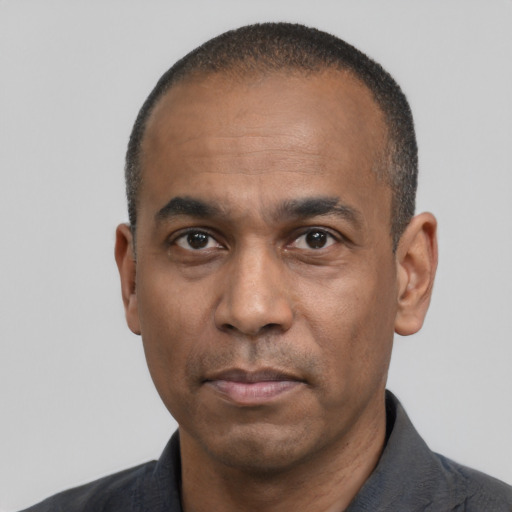 Neutral latino adult male with short  black hair and brown eyes