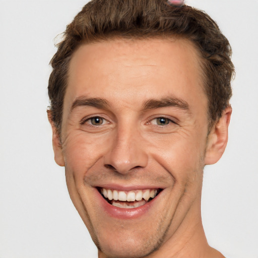 Joyful white adult male with short  brown hair and brown eyes