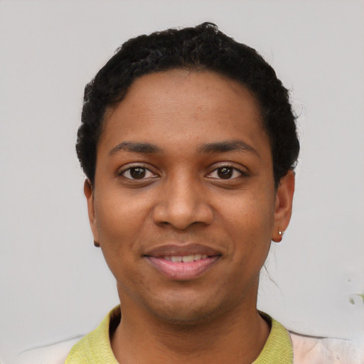 Joyful black young-adult female with short  black hair and brown eyes