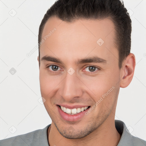 Joyful white young-adult male with short  brown hair and brown eyes