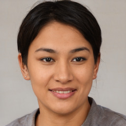 Joyful asian young-adult female with short  brown hair and brown eyes