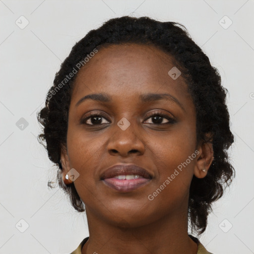 Joyful black young-adult female with long  black hair and brown eyes