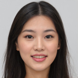 Joyful asian young-adult female with long  brown hair and brown eyes