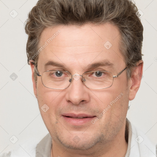 Joyful white adult male with short  brown hair and grey eyes