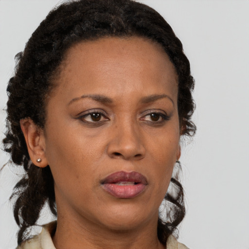 Joyful black adult female with short  brown hair and brown eyes