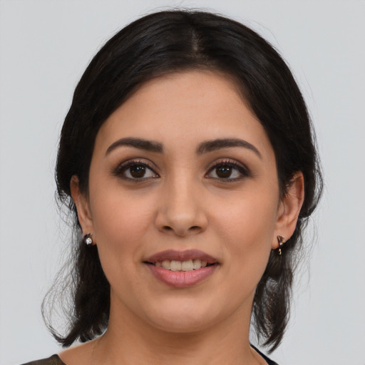 Joyful latino young-adult female with medium  black hair and brown eyes
