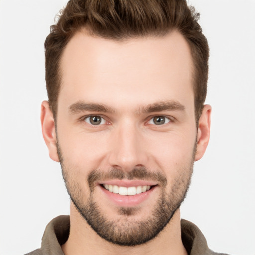 Joyful white young-adult male with short  brown hair and brown eyes