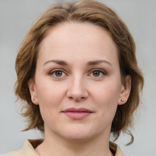 Joyful white young-adult female with medium  brown hair and green eyes