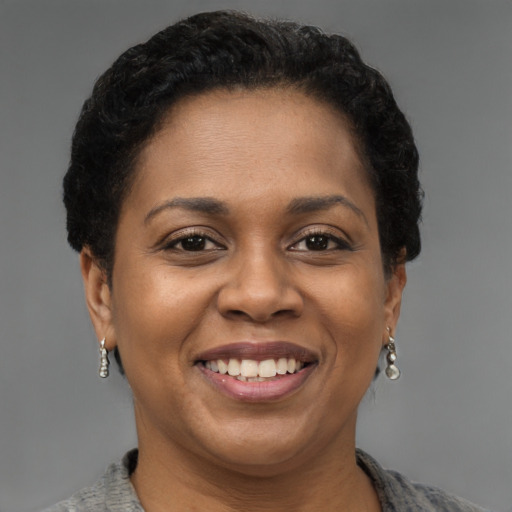 Joyful latino adult female with short  brown hair and brown eyes