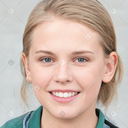 Joyful white young-adult female with medium  brown hair and blue eyes