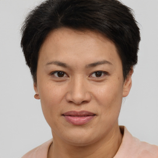 Joyful asian adult female with short  brown hair and brown eyes