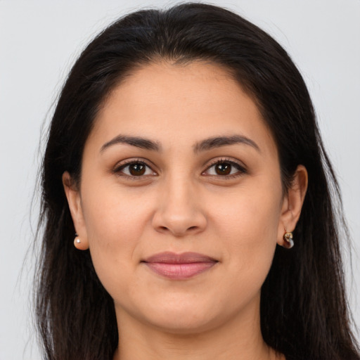 Joyful latino young-adult female with long  brown hair and brown eyes