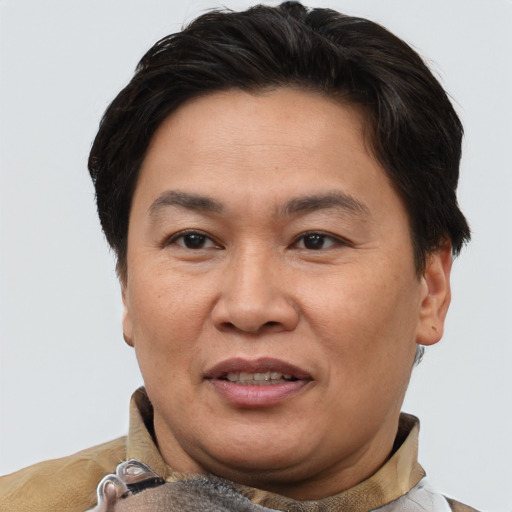 Joyful asian adult male with short  brown hair and brown eyes