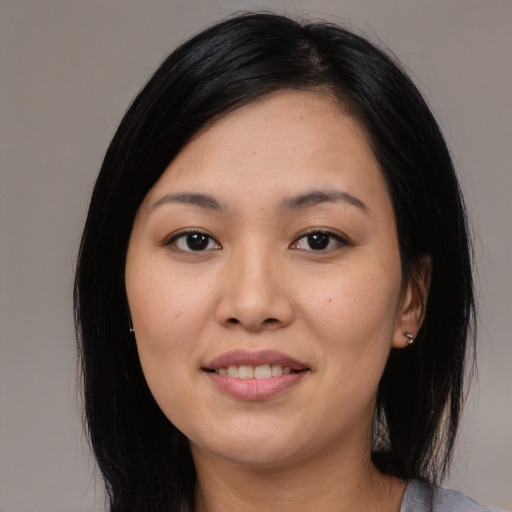Joyful asian young-adult female with medium  black hair and brown eyes