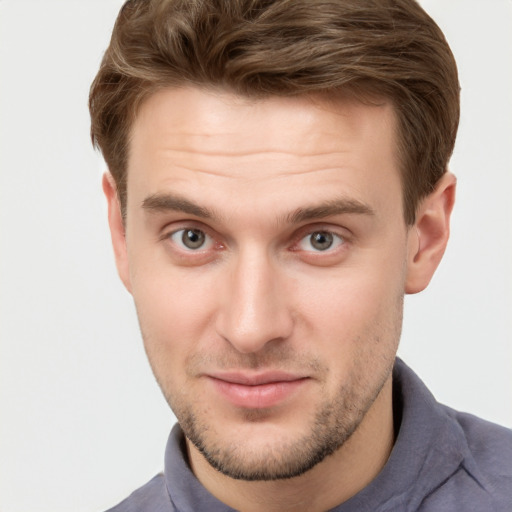 Joyful white young-adult male with short  brown hair and grey eyes