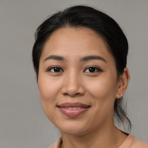 Joyful latino young-adult female with medium  black hair and brown eyes