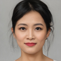 Joyful asian young-adult female with medium  black hair and brown eyes