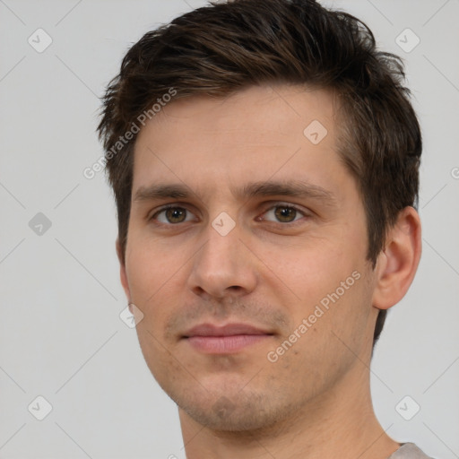 Joyful white young-adult male with short  brown hair and brown eyes