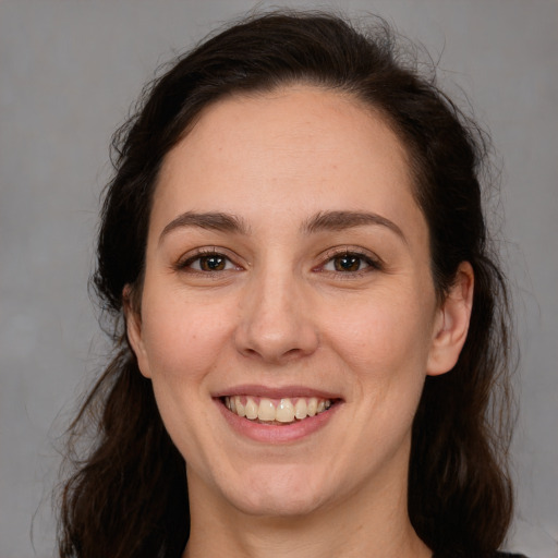 Joyful white adult female with medium  brown hair and brown eyes