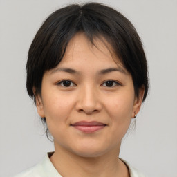 Joyful asian young-adult female with medium  brown hair and brown eyes