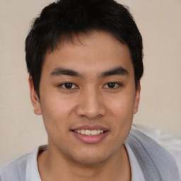 Joyful latino young-adult male with short  brown hair and brown eyes