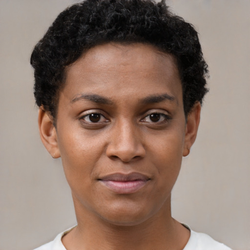 Joyful black young-adult female with short  brown hair and brown eyes