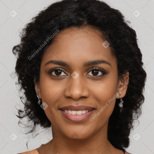 Joyful black young-adult female with long  black hair and brown eyes