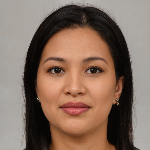 Joyful latino young-adult female with long  brown hair and brown eyes