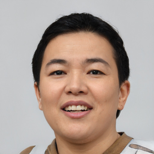 Joyful asian young-adult female with short  black hair and brown eyes