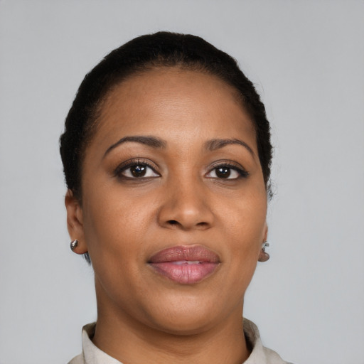 Joyful black young-adult female with short  brown hair and brown eyes