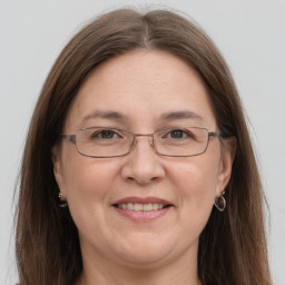 Joyful white adult female with long  brown hair and grey eyes