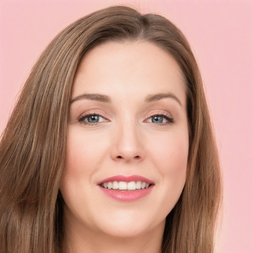 Joyful white young-adult female with long  brown hair and green eyes