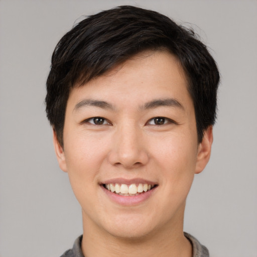 Joyful asian young-adult male with short  brown hair and brown eyes
